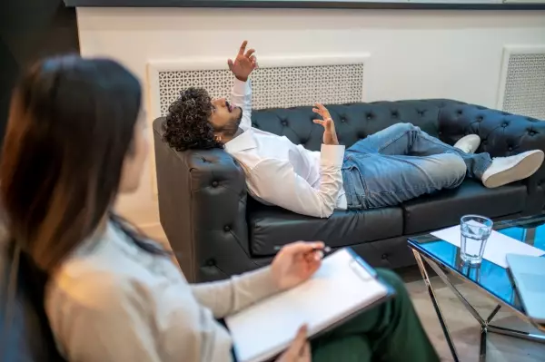 young-man-lying-couch-psychotherapist-office-talking-about-his-psychological-problems